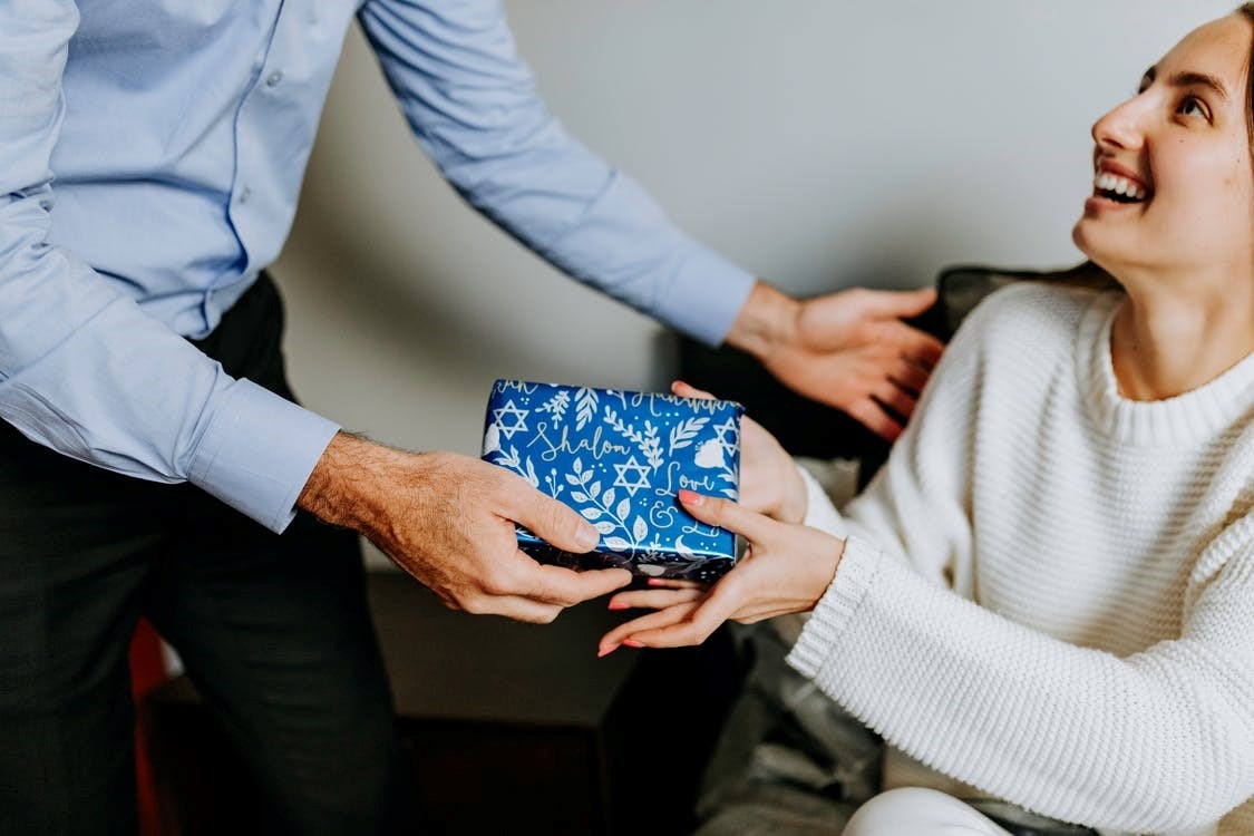 A man giving a gift to a woman