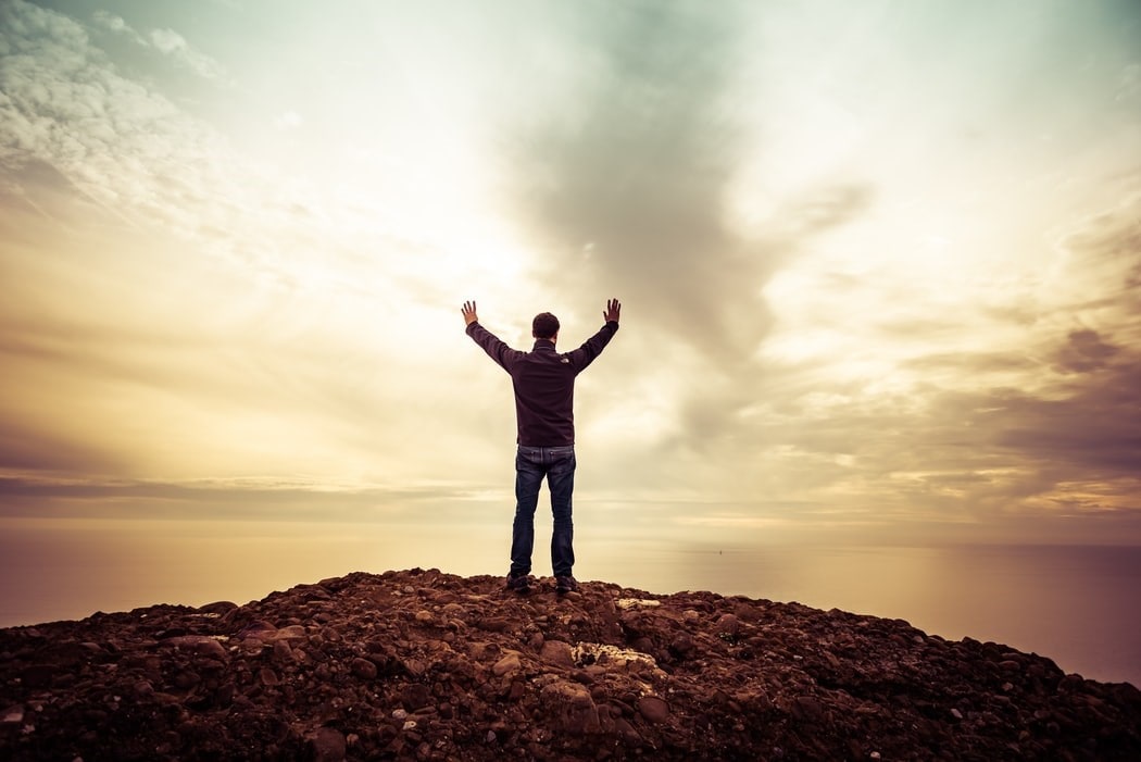 Man standing at the edge of a cliff