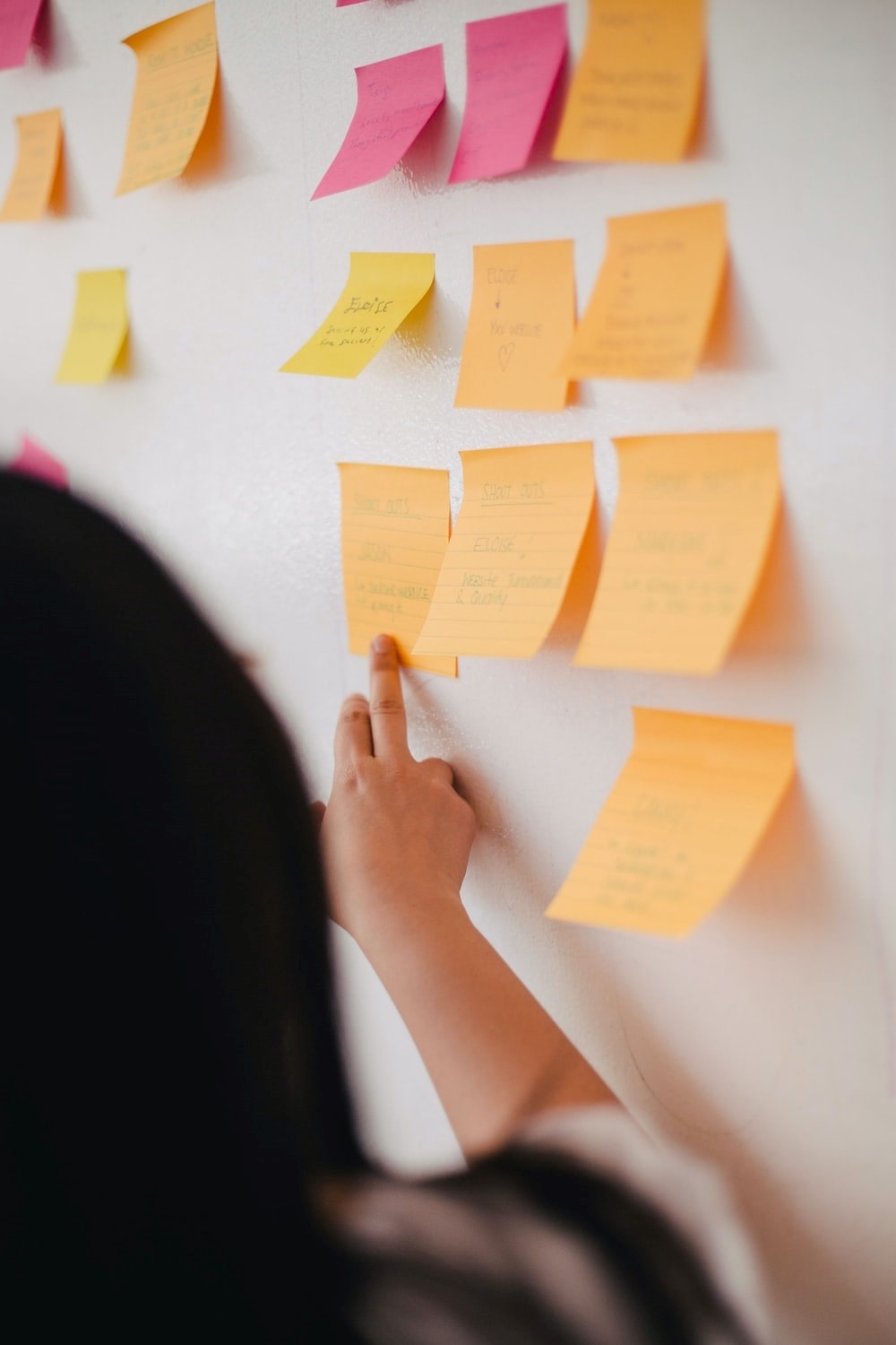 Woman reading from a post it