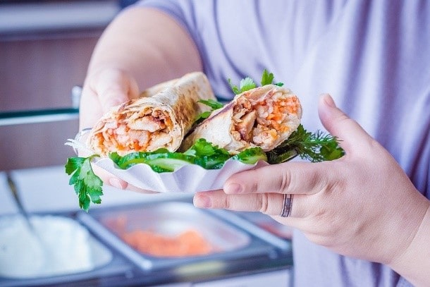 A person showing authentic Israeli shawarma