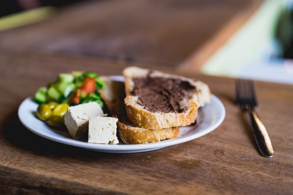 A plate of food with fork on a wooden table