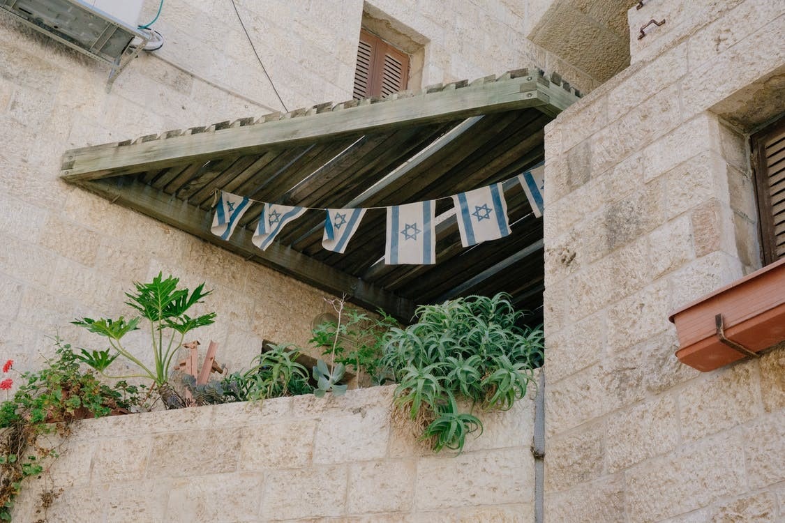 Israel flags hanging on a building