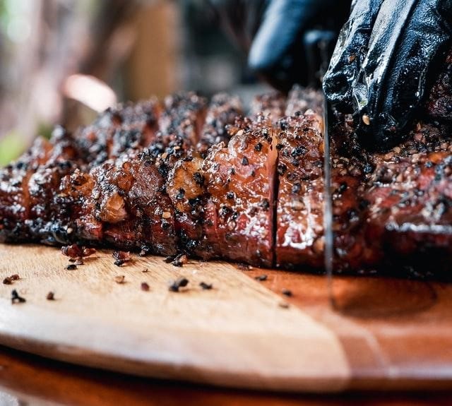 A chef cutting a brisket