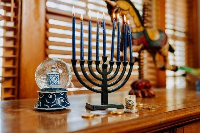 Lit menorah candles on a table