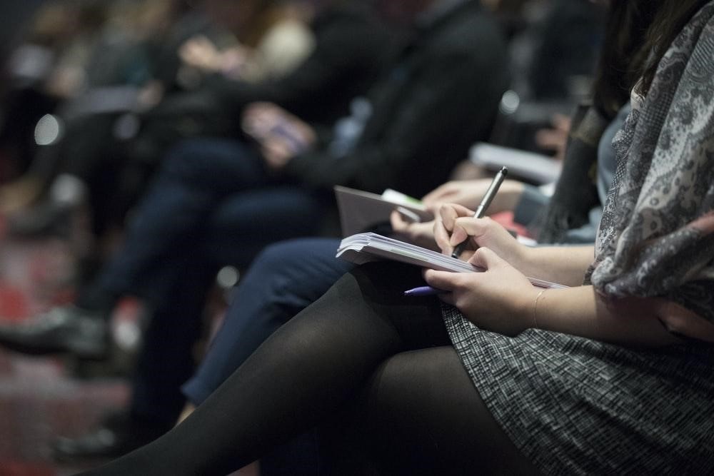 Adult woman taking notes in class