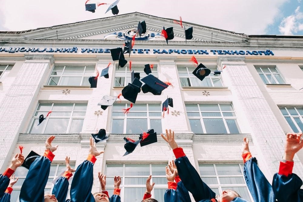 Students throwing graduation caps in the air