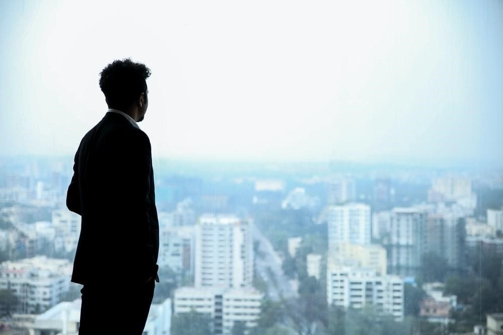 person on a rooftop looking at other buildings